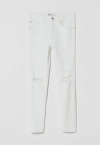 Jeans skinnies de mezclilla blanca con rotos desgastados en las rodillas, que cuentan con un diseño clásico de cinco bolsillos y un cierre de botón metálico en la cintura.