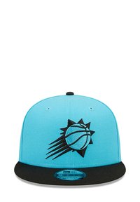 Blue snapback cap with a black brim, featuring a black embroidered basketball logo with sun rays on the front. Smooth fabric texture.
