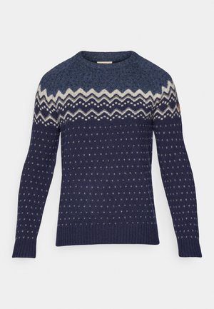 Navy blue knitted sweater with cream zigzag and dotted patterns. Crew neck, ribbed cuffs and hem, medium texture, casual fit.
