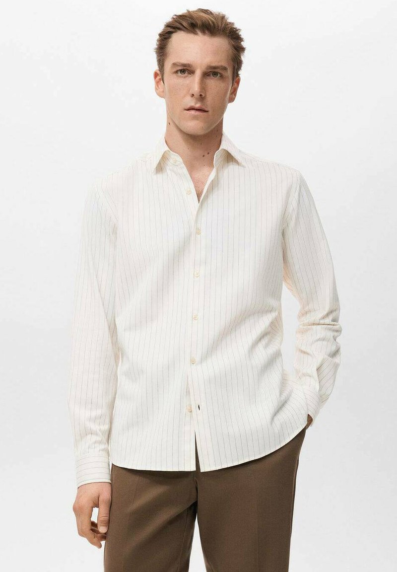 Camisa blanca de manga larga con finas rayas verticales, con cuello abotonado y corte recto. Textura lisa y detalles mínimos.