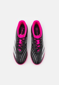 Scarpe da calcio nere con accenti rosa, caratterizzate da una superficie texturizzata, un design elegante e motivi a gradiente bianchi. Lacci neri.