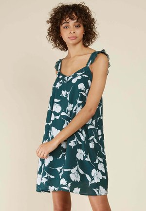 Robe sans manches teal avec un motif floral blanc, bretelles en dentelle, coupe ample et décolleté carré, fabriquée en tissu léger.