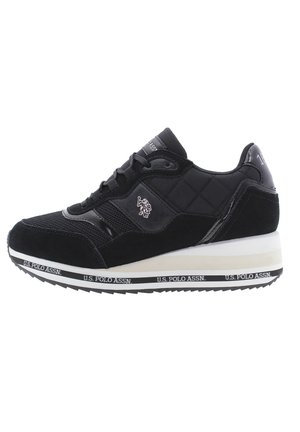 Black athletic shoe featuring a quilted design, suede and synthetic materials, laces, and a white midsole with black branding.
