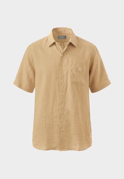 Beež lühikeste varrukatega särgi, millel on krae ja rinnatasku Polo Ralph Laureni logoga, valmistatud kerge kangast.