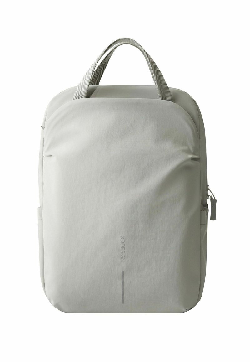 Sac à dos gris clair au design épuré et minimaliste, réalisé en tissu lisse, avec des poignées supérieures et une poche zippée sur le côté.