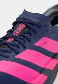 Scarpa sportiva blu navy e rosa con lacci blu navy scuro e la parola "ADIZERO" in rosa sulla linguetta.