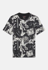 Black and white graphic t-shirt featuring various basketball-related images, patterns, and the number "23" throughout the design.