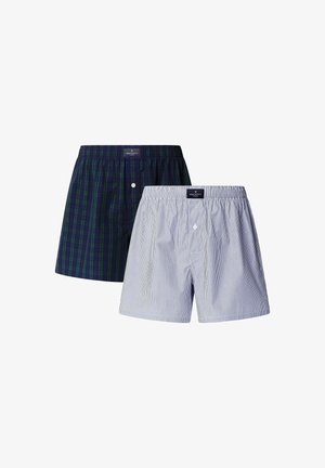 Dva páry pánskych boxeriek: jedny v tmavozelenej a námorníckej kocke s gombíkom, druhé v svetlomodrej a bielej pruhovanej. Mäkká bavlnená tkanina.