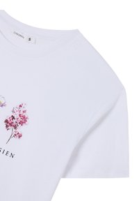 T-shirt bianca in cotone con stampa floreale in rosa e viola, maniche corte e scollo rotondo. Etichetta della taglia visibile.