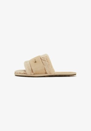 Beige suede slide sandals with plush furry straps and a flat sole. Notable gold accent on the strap adds detail. Soft texture throughout.