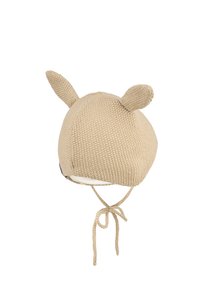 Beige knitted baby hat with two small ears and tied straps under the chin, shown on a white background.