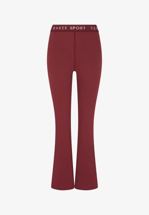 Sportovní legíny se zvonovými nohavicemi v tmavě vínové barvě, vyrobené z elastické látky. Disponují jednobarevným provedením a potištěným pasem s nápisem "BAKER SPORT".