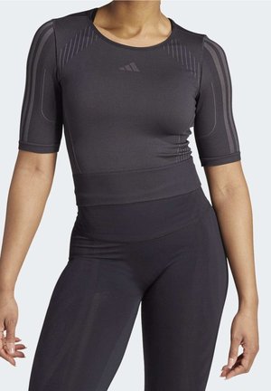 Black athletic top with short sleeves and a fitted design. Features subtle stripes and branding. Smooth texture, lightweight material.