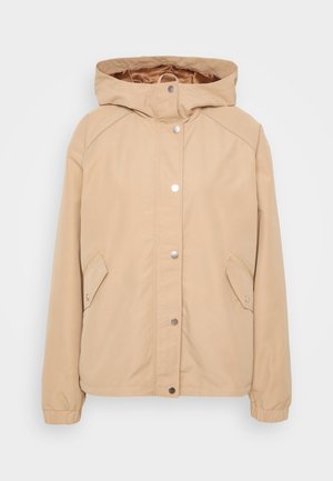Beige hooded jacket with snap closure, side pockets, elasticated sleeves, and smooth texture. Reinforced shoulder seams and interior lining visible.