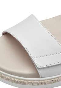 Sandal in pelle bianca con un'ampia fascetta, cuciture incise e una suola testurizzata con un accento di corda naturale attorno alla base.