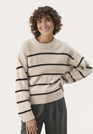 Beige striped sweater with thin black horizontal lines, ribbed collar and cuffs, featuring a relaxed fit. Paired with gray trousers.