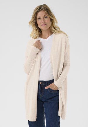 Light beige open cardigan made of soft knit fabric, featuring long sleeves with ribbed cuffs, worn over a white V-neck t-shirt and blue jeans.