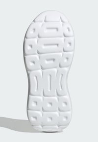 Semelle de sneaker blanche présentant une surface texturée avec des motifs rectangulaires et ovales en relief, conçue pour l'adhérence et la stabilité.