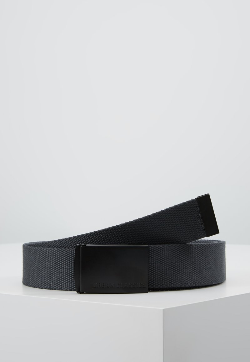 Black woven belt with a textured fabric, featuring a matte black rectangular buckle and embossed "URBAN CLASSICS" logo. Adjustable length.