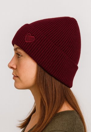 Burgundy ribbed knit beanie featuring a small red heart embroidery, designed for a snug fit and warmth.