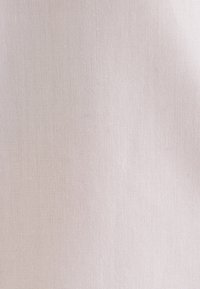 Light pink fabric with a smooth texture and subtle weave pattern. Even color distribution with no visible patterns or embellishments.