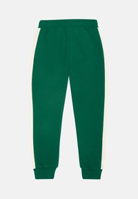 Gröna sweatpants i bomull med elastisk midja och vita sidostråk, med ribbade muddar och en slät yta.
