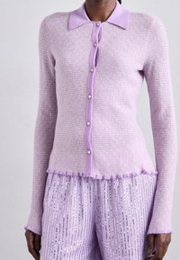 Light purple knit cardigan with a collar, seven button closure, and frayed hem. The fabric has a textured pattern and long sleeves.