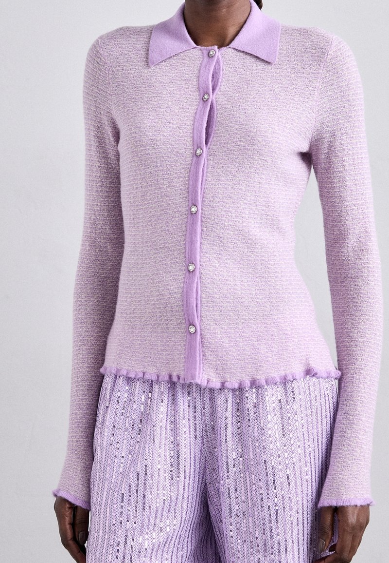 Light purple knit cardigan with a collar, seven button closure, and frayed hem. The fabric has a textured pattern and long sleeves.