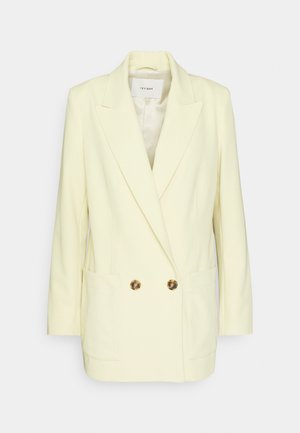 Διπλής όψης σακάκι σε ανοιχτό κίτρινο, με κομψό σχέδιο, αυλακωτούς γιακάδες, δύο μπροστινές τσέπες και κουμπιά σε χρυσό τόνο. Λείος υφασμάτινος σκελετός.