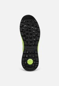 Schwarze Gummi-Außensohle mit tiefen Rillen, ausgestattet mit einer lebhaften grünen Kante und einem sechseckigen Design. Strukturiert Oberfläche für besseren Grip.
