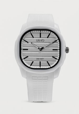 Biały zegarek na nadgarstek z teksturowanym paskiem, kwadratową srebrną tarczą, czarnymi oznaczeniami godzin i wskazówkami pokazującymi 10:10, oznaczony napisem "LIU·JO" i "30M/100FT".