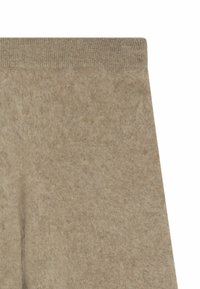 Beiga ullleggings med en mjuk, texturerad finish. Har en ribbstickad midja och en sömlös design, lämplig för vardagsbruk.