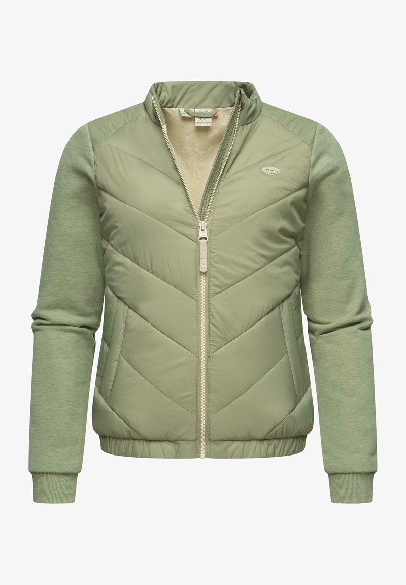 Šviesiai žalia užtrauktuku užsegama striukė su chevron siuvinėjimu priekyje, minkštomis mezginio rankovėmis ir guminiais uždengimais. Yra stovinti apykaklė ir subtilus logotipo raštas.