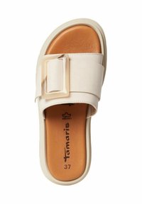 Savatte délicate en crême avec une large sangle ornée d'une grande boucle rectangulaire, semelle intérieure rembourrée couleur beige et semelle en caoutchouc blanche. Taille 37.