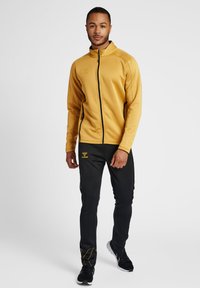 Hummel JACKET - Trainingsjacke - antique gold