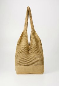 Woven straw tote bag in light beige, featuring a spacious open top, wide straps, and a solid base with a subtle textured pattern.