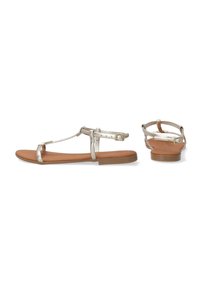 Metallische zilveren platte sandalen met een T-band ontwerp, tan kleurige faux leren binnenzool en verstelbare enkelgesp. Minimalistisch en modern.