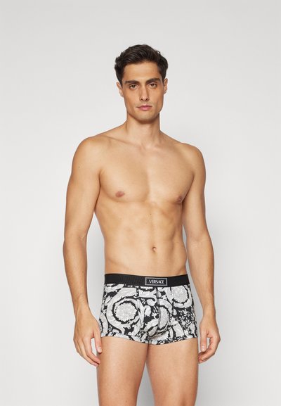 Black and white patterned boxer briefs with a snug fit. Features a branded elastic waistband and intricate floral designs throughout.