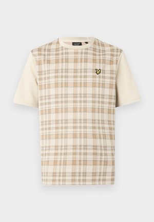 Kortärmad beige rutig t-shirt med ljusbruna och vita mönster, med en liten svart och gul broderad logotyp på bröstet.