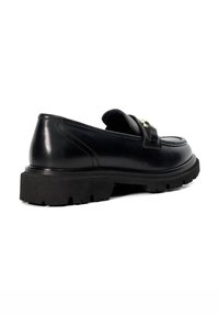 Black leather loafers with a chunky rubber sole. Features a decorative strap with hardware and a rounded toe design. Smooth texture.