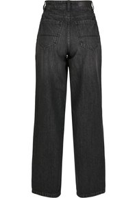 Pantalons en denim noir à jambe large avec une taille haute, dotés de deux poches arrière et d'une finition épurée. Le tissu semble robuste et texturé.