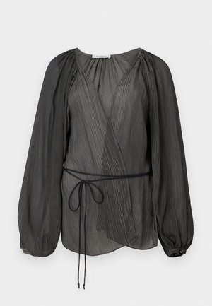 Black pleated wrap blouse featuring long, puffed sleeves, a tie belt, and a lightweight, textured fabric. Circular button accent at the cuff.