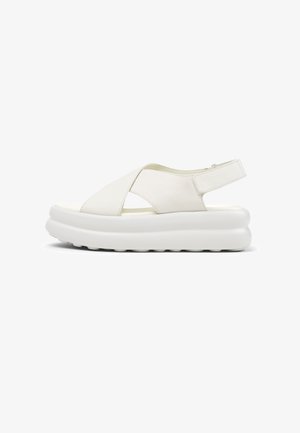 White leather sandal with cross-strap design, adjustable backstrap, and a thick white platform sole featuring textured underside.