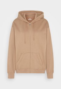 Beige zip-up hoodie with a drawstring hood, two front pockets, ribbed cuffs and hem, made of soft cotton fabric.