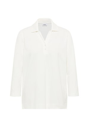 Chemise polo blanche à manches longues avec col, dotée d'une patte de boutonnage à trois boutons, texture douce et coupe décontractée. L'étiquette indique "CECIL".