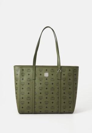 Green leather tote bag with black MCM logos and symbols, dual handles, and a small silver brand plaque on front center.