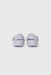 Light purple slip-on clogs with a textured sole and a raised back strap for ankle support. Smooth material with a glossy finish.