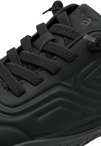 Black sneaker featuring a textured upper, prominent lacing system, and molded design accents on the side. Made of synthetic material.