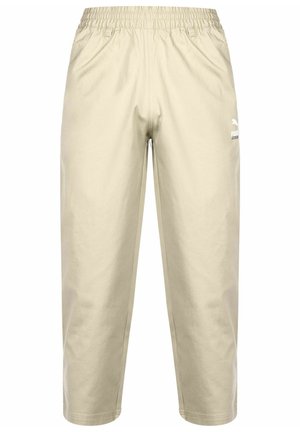 Beige joggebukser med elastisk liv. Laget av mykt materiale, med en hvit logo på venstre bein og en avslappet, cropped passform.