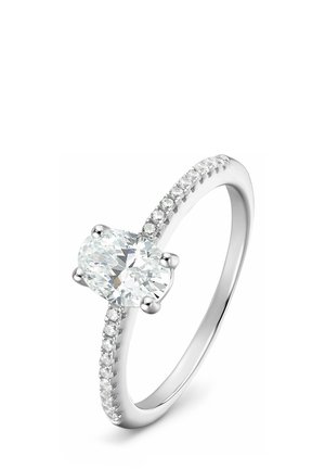 Weißgoldring mit einem oval geschliffenen mittleren Diamanten und einem mit kleinen runden Diamanten verzierten Ringband.